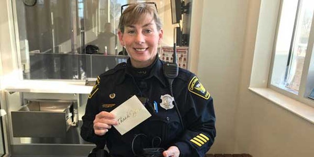 Cincinnati Police Officer Virginia Villing holds the thank you note and GPS system.