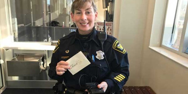 Cincinnati Police Officer Virginia Villing holds the thank you note and GPS system.