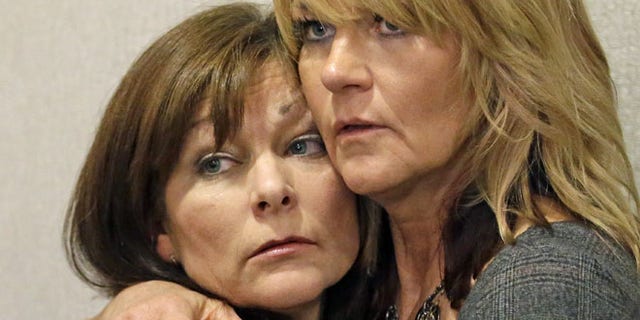 Sept. 19, 2014: Susan Hunt, left, the mother of Darrien Hunt, is hugged by her sister, Cynthia Moss, during a news conference in Salt Lake City. (AP)