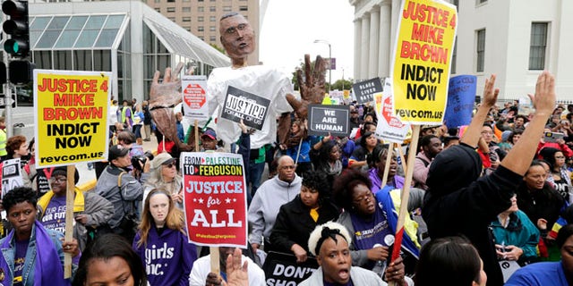 Oct. 11, 2014: Protesters march near the St. Louis Arch in St Louis. (AP)