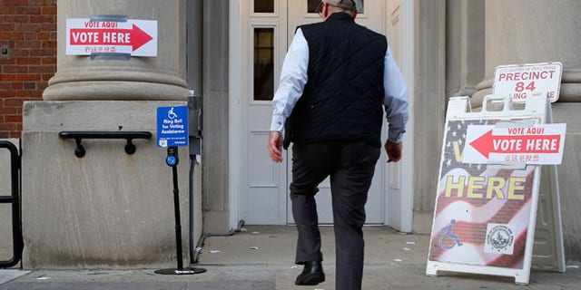 FILE: Nov. 4, 2014: A voter enters the polling place at Stuart-Hobson Middle School on Capitol Hill, in Washington, D.C.