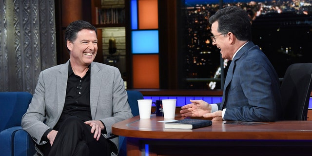 This image released by CBS shows former FBI Director James Comey, left, with host Stephen Colbert on "The Late Show with Stephen Colbert."