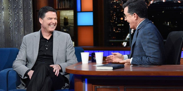 This image released by CBS shows former FBI Director James Comey, left, with host Stephen Colbert on "The Late Show with Stephen Colbert."