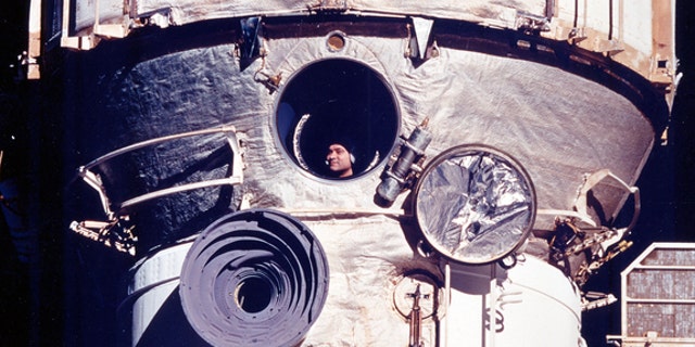 Cosmonaut Valery Polyakov looks out the Russian space station Mir's window during his record-setting 438-day mission from 1994 to 1995.