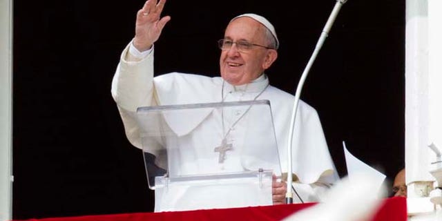 Feb. 22, 2015: Pope Francis waves to faithful from his studio window overlooking St. Peter's Square, during the Angelus noon prayer at the Vatican.