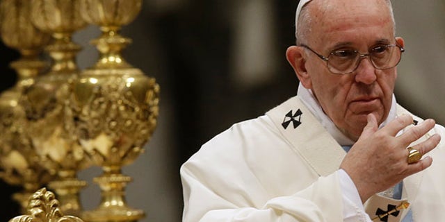 Jan. 1, 2016: Pope Francis makes the sign of the cross as he celebrates a New Year mass in St. Peter's Basilica at the Vatican. (AP)