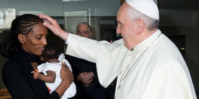 July 24, 2014: In this photo provided by the Vatican newspaper L'Osservatore Romano, Pope Francis meets Meriam Ibrahim, from Sudan, with her daughter Maya in her arms, in his Santa Marta residence, at the Vatican. The Sudanese woman who was sentenced to death in Sudan for refusing to recant her Christian faith has arrived in Italy along with her family, including the infant born in prison. (AP)