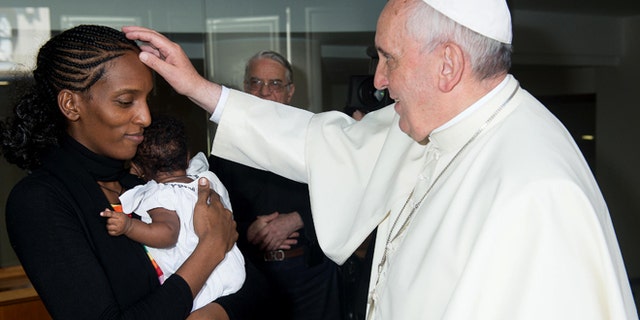 July 24, 2014: In this photo provided by the Vatican newspaper L'Osservatore Romano, Pope Francis meets Meriam Ibrahim, from Sudan, with her daughter Maya in her arms, in his Santa Marta residence, at the Vatican. The Sudanese woman who was sentenced to death in Sudan for refusing to recant her Christian faith has arrived in Italy along with her family, including the infant born in prison. (AP)