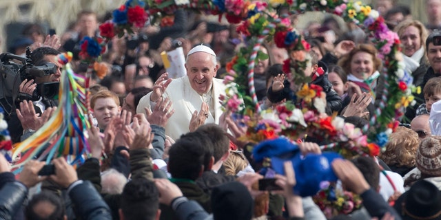 Pope Francis is cheered as he is driven through the crowd ahead of his weekly general audience in St. Peter's Square, at the Vatican, Wednesday, Feb. 26, 2014.