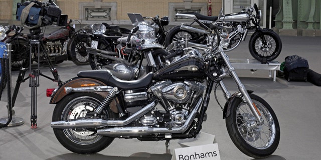 Feb. 5, 2014: The 2013 Harley Davidson Super Glide Custom A 1,585cc Harley-Davidson Dyna Super Glide, donated to Pope Francis last year and signed by him on its tank, is displayed ahead of Bonham's sale of vintage and classic cars, at the Grand Palais in Paris.