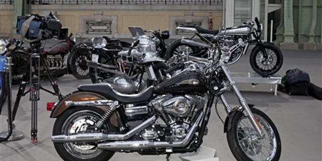 The 2013 Harley DavidsonSuper Glide Custom A 1,585cc Harley-Davidson Dyna Super Glide, donated to Pope Francis last year and signed by him on its tank, is displayed ahead of Bonham's sale of vintage and classic cars, at the Grand Palais in Paris, Wednesday, Feb. 5, 2014. The bike will be sold at auction to help raise funds for a soup kitchen and hostel for the homeless in Rome. (AP Photo/Thibault Camus)
