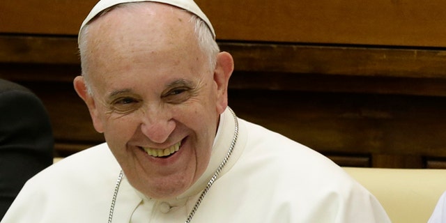 Pope Francis smiles as he arrives to attend a two-day summit of judges and magistrates against human trafficking and organized crime, at the Vatican, Friday, June 3, 2016. Judges and prosecutors from around the world are pledging to crack down on human trafficking and help victims of modern-day slavery in the latest Vatican initiative to draw attention to the problem and rally resources to fight it. (AP Photo/Gregorio Borgia)