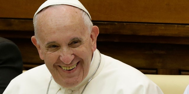 Pope Francis smiles as he arrives to attend a two-day summit of judges and magistrates against human trafficking and organized crime, at the Vatican, Friday, June 3, 2016. Judges and prosecutors from around the world are pledging to crack down on human trafficking and help victims of modern-day slavery in the latest Vatican initiative to draw attention to the problem and rally resources to fight it. (AP Photo/Gregorio Borgia)