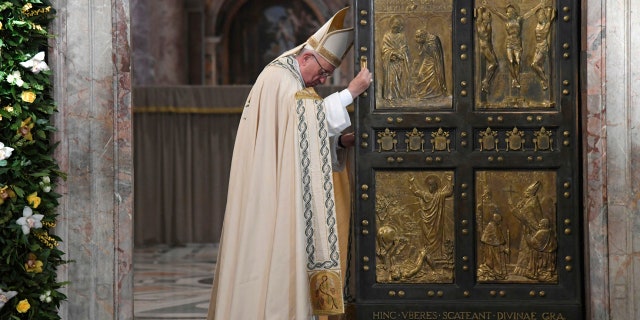 Pope Francis closes the Holy Door of St. Peter's Basilica at the Vatican, Sunday, Nov. 20, 2016. Pope Francis has pulled shut the Holy Door of St. Peters Basilica, formally ending the Holy Year of Mercy he declared to highlight that virtue. (Tiziana Fabi/pool photo via AP)