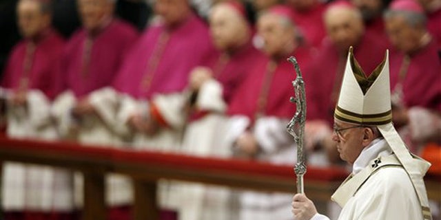 Pope Francis arrives to celebrate the Christmas Eve Mass in St. Peter's Basilica at the Vatican, Thursday, Dec. 24, 2015. (AP Photo/Gregorio Borgia)