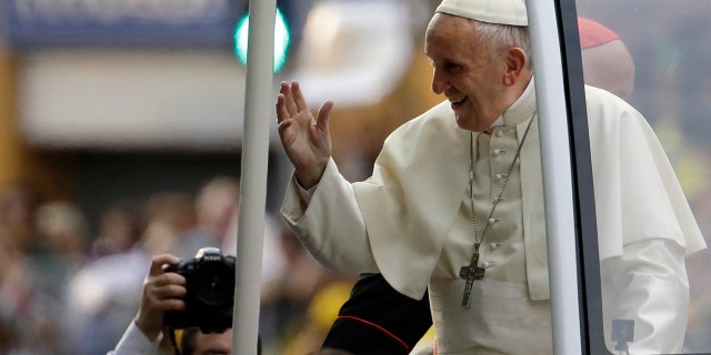 Pope Francis waves to followers on his way to the Apostolic Nunciature in Santiago, Chile, Monday, Jan. 15, 2018. (AP Photo/Natacha Pisarenko)