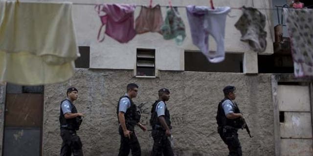 July 21, 2013: Policemen from the Pacifying Police Unit, or 'UPP', patrol in the Varginha area of the Manguinhos slum complex ahead of Pope Francis' visit to Rio de Janeiro, Brazil.