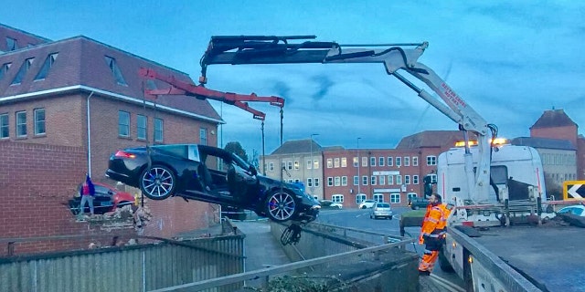 Emergency services needed to use a crane to remove the vehicle.