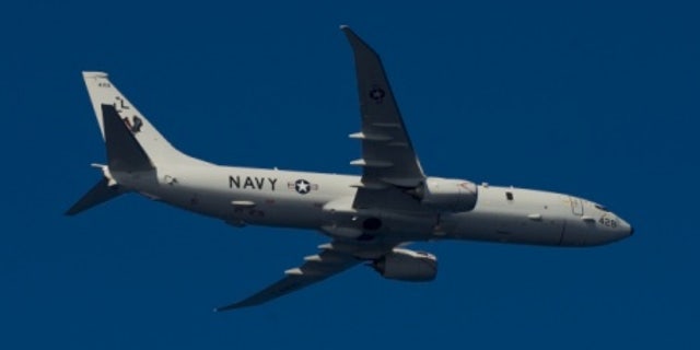 File photo - A P-8A Poseidon, assigned to Patrol Squadron (VP) 30, flies over the aircraft carrier USS Harry S. Truman (U.S. Navy photo by Mass Communication Specialist 2nd Class Mike DiMestico/Released).
