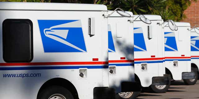 U.S. postal service trucks sit parked at the post office. A postal worker was shot and killed Friday evening while delivering mail in Milwaukee, Wisconsin. 