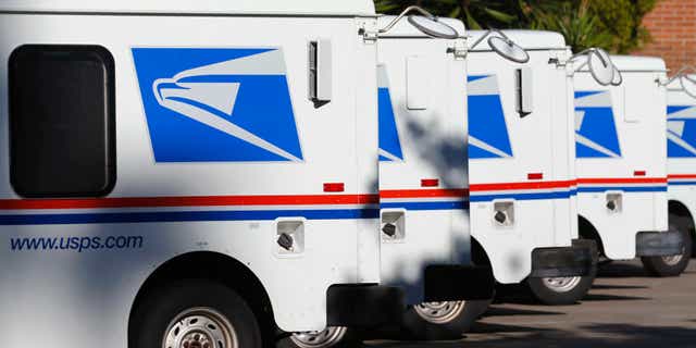 U.S. postal service trucks sit parked at the post office. A postal worker was shot and killed Friday evening while delivering mail in Milwaukee, Wisconsin. 