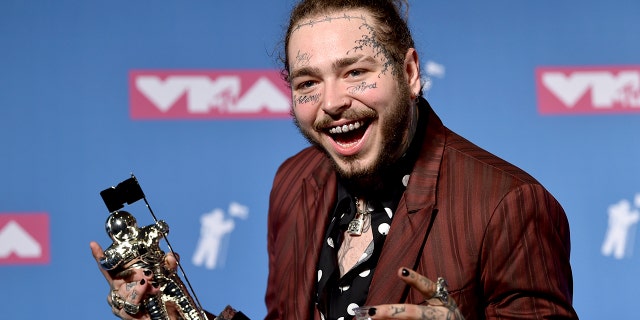Post Malone poses with the award for song of the year for "Rockstar" in the press room at the MTV Video Music Awards at Radio City Music Hall on Monday, Aug. 20, 2018, in New York.