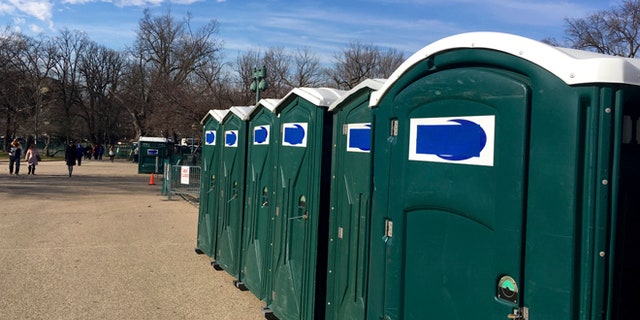 A row of portable restrooms, with the name Dons Johns covered up, is seen on Capitol Hill in Washington, Friday, Jan. 13, 2017. Virginia-based Dons Johns calls itself the Washington areas top provider of portable toilet rentals, but the name apparently strikes too close to home for inaugural organizers. Workers have placed blue tape over the brand name on dozens of portable restrooms installed near the Capitol for the inauguration. (AP Photo/Matthew Daly)