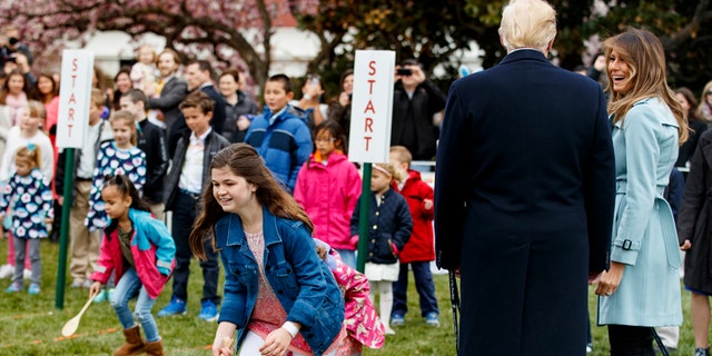 First lady Melania Trump looks to President Donald Trump at the White House in Washington, Monday, April 2, 2018, during the annual White House Easter Egg Roll. (AP Photo/Carolyn Kaster)