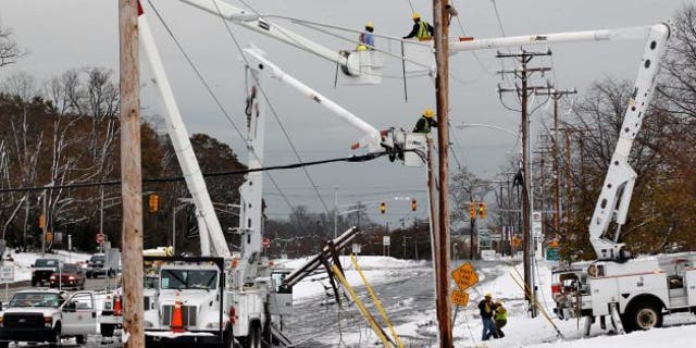 Utility workers fixing power lines in Eatontown NJ after superstorm Sandy and a Nor'easter have a 1-2 punch to the eastern seaboard earlier this month.