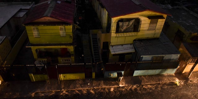 Vehicle lights illuminate a street after a massive blackout, in San Juan, Puerto Rico, Thursday, Sept. 22, 2016.
