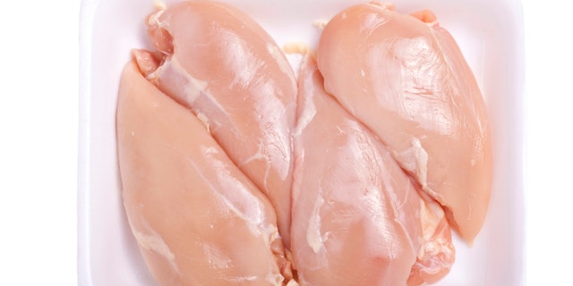 Raw boneless and skinless chicken breast in a styrofoam tray or container.