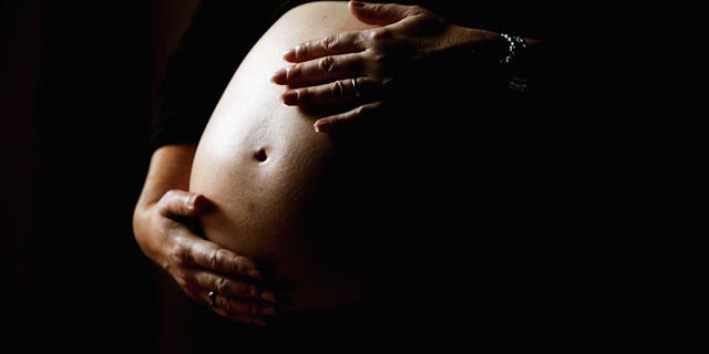 SYDNEY, NSW - JUNE 07: A pregnant woman holds her stomach June 7, 2006 in Sydney, Australia. Australia is currently enjoying a baby boom, with the Australian Bureau of Statistics registering a 2.4% increase in births from 2004 to 2005, which represents the highest number of births since 1992. The Australian Federal Government has been encouraging people to have more babies, with financial incentives and the slogan by treasurer Peter Costello to "have one for mum, one for dad, and one for the country". The Federal Government has identified falling fertility rates and the ageing population as long-term problems for Australia's growth and prosperity. (Photo by Ian Waldie/Getty Images)
