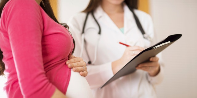 A young pregnant woman visits with her doctor. For a new study, researchers evaluated over 238,000 adults ages 19-64 who obtained health care coverage through an employer or union from 2000 to 2020.