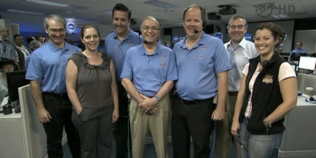 The team behind NASA's Mars rover Curiosity's Aug. 5 landing take a call from President Barack Obama on Aug. 13, 2012. At center is NASA Jet Propulsion Laboratory director Charles Elachi. Obama called the Mars landing "mindboggling."