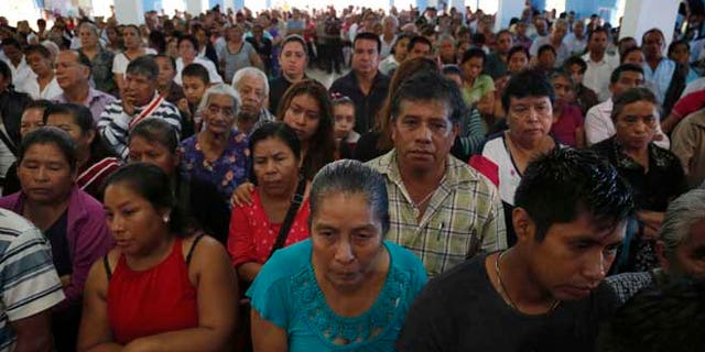 This Sept. 21, 2016 photo shows a packed Our Lady of Asuncion Church for the funeral Mass of slain Rev. Jose Alfredo Suarez de la Cruz, who was found bound and shot to death alongside another priest, in Paso Blanco, Veracruz state, Mexico, his hometown. The killings in the troubled Gulf state of Veracruz came at a moment of heightened tension between the Roman Catholic Church and Mexicoââ¬â¢s government. (AP Photo/Marco Ugarte)