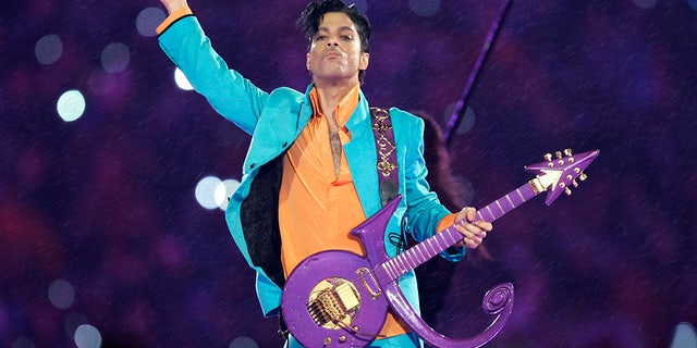 FILE - In this Feb. 4, 2007, file photo, Prince performs during the halftime show at the Super Bowl XLI football game at Dolphin Stadium in Miami. Thousands of Prince fans have signed a petition asking federal authorities to open a grand jury investigation into his 2016 death. (AP Photo/Chris O'Meara, File)
