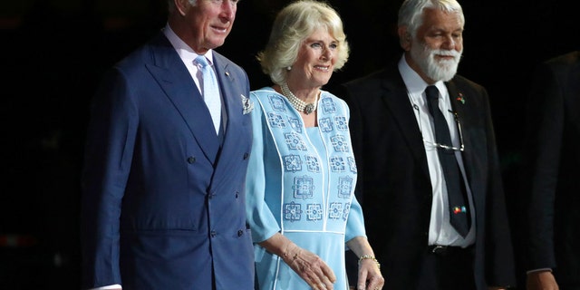 Prince Charles, left and Camilla, Duchess of Cornwall, center, arrive with Aboriginal Elder Ted Williams during the opening ceremony for the 2018 Commonwealth Games at Carrara Stadium on the Gold Coast, Australia, Wednesday, April 4, 2018. (AP Photo/Dita Alangkara)