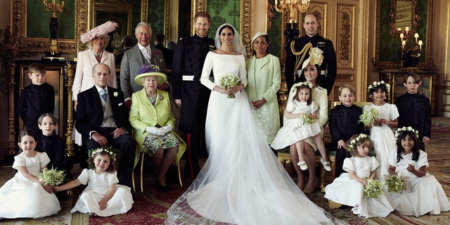 An official wedding photo of Britain's Prince Harry and Meghan Markle, center, in Windsor Castle, Windsor, England, Saturday, May 19, 2018. (Alexi Lubomirski/Kensington Palace via AP)
