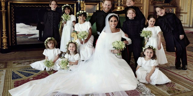 Prince Harry and Meghan Markle, center, in Windsor Castle, Windsor, England, Saturday May 19, 2018. Others in photo from left, back row, Brian Mulroney, Remi Litt, Rylan Litt, Jasper Dyer, Prince George, Ivy Mulroney, John Mulroney; front row, Zalie Warren, Princess Charlotte, Florence van Cutsem.