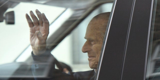 Britain's Prince Philip waves as he leaves the King Edward VII Hospital, after recovering from a planned surgery last Wednesday, in London, Friday, April 13, 2018. (Victoria Jones/PA via AP)