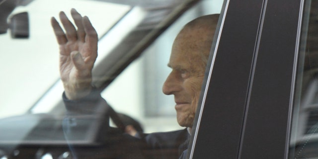 Britain's Prince Philip waves as he leaves the King Edward VII Hospital, after recovering from a planned surgery last Wednesday, in London, Friday, April 13, 2018. (Victoria Jones/PA via AP)