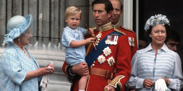 A young Prince William clings tight to his father, Prince William, during the Trooping the Colour festivities in 1984.
