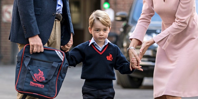 Britain's Prince William accompanies Prince George as he is met by Helen Haslem - the head of the lower school on arrival for his first day of school at Thomas's school in Battersea, London, Thursday, Sept. 7, 2017. Prince William's pregnant wife Kate was too ill with morning sickness Thursday to take young Prince George to his first day of school. (Richard Pohle/Pool Photo via AP)