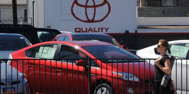 April 6: A woman walks past Toyota Prius cars for sale at a Toyota dealer in Hollywood. (AFP)