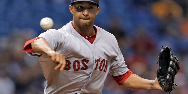 Boston Red Sox reliever Anthony Varvaro tries to pick off a Tampa Bay Ray baserunner during a game in St. Petersburg.