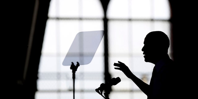ANN ARBOR, MI - APRIL 2: U.S. President Barack Obama is silhouetted as he speaks about his proposal to raise the federal minimum wage at the University of Michigan on April 2, 2014 in Ann Arbor, Michigan. Obama said every American deserves a fair working wage.(Photo by Joshua Lott/Getty Images)