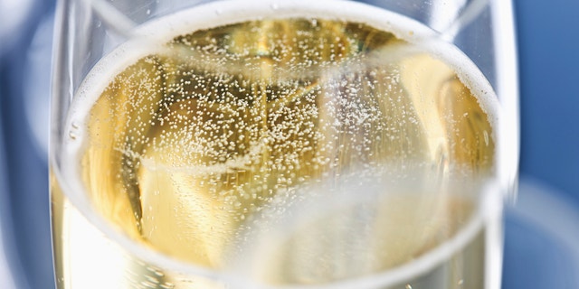 Close up of champagne bubbling in a champagne flute.