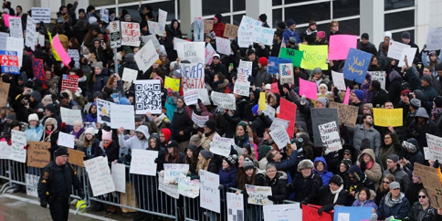 Hundreds of people rally against a temporary travel ban signed by U.S. President Donald Trump in an executive order during a protest at Detroit Metropolitan airport in Romulus, Michigan, U.S., January 29, 2017.