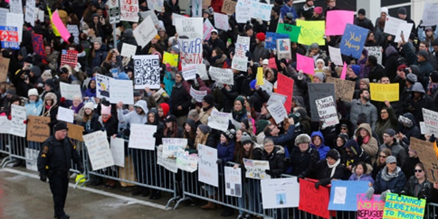 Hundreds of people rally against a temporary travel ban signed by U.S. President Donald Trump in an executive order during a protest at Detroit Metropolitan airport in Romulus, Michigan, U.S., January 29, 2017.