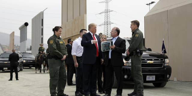 President Donald Trump reviews border wall prototypes on Tuesday in San Diego.